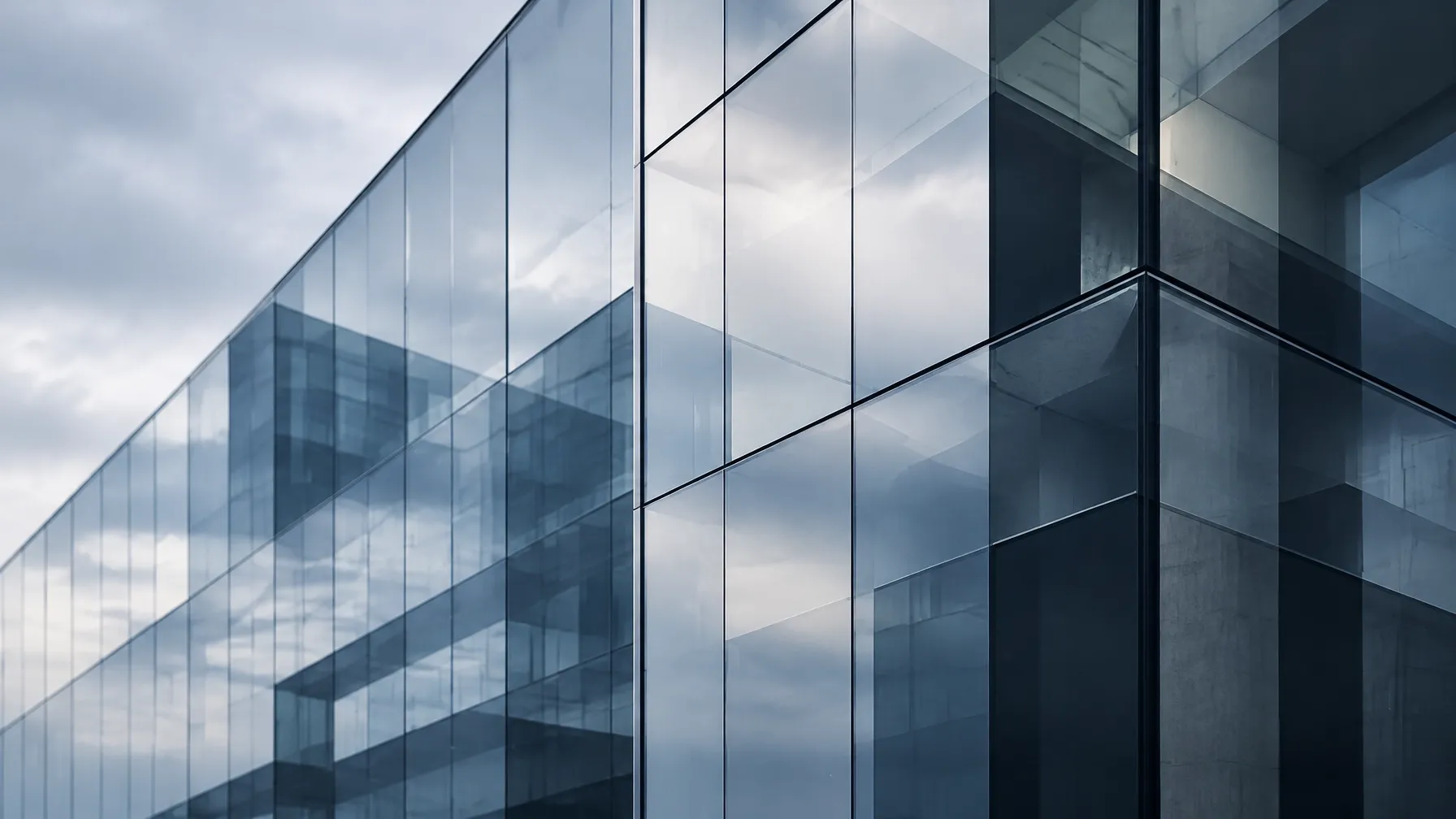 Modern glass office facade in cool blue-grey daylight